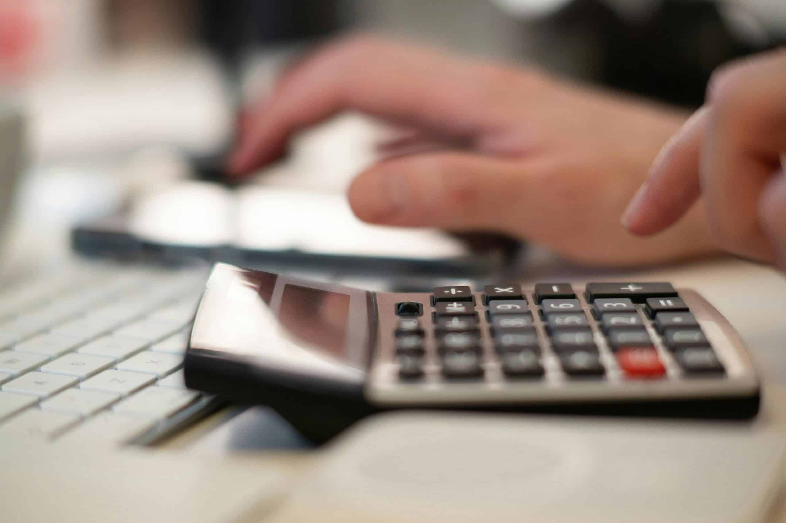 merchant statement line items review on calculator and keyboard
