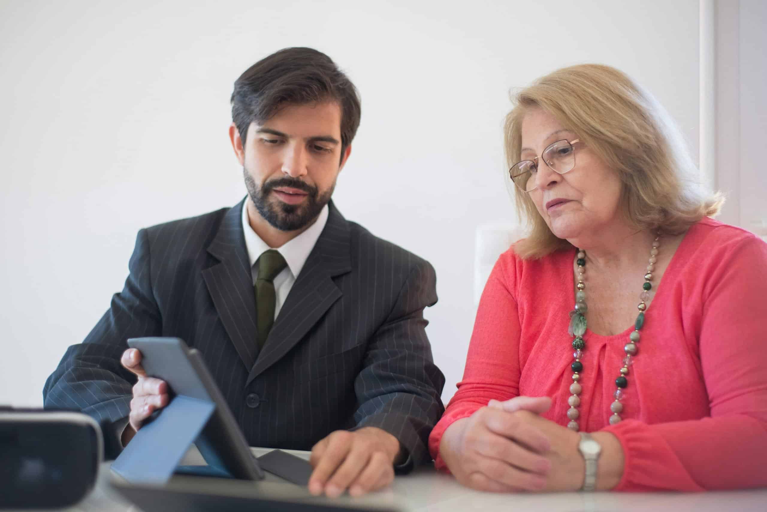 CPA reviewing hidden statement fees on merchant processing statement with small business client during tax preparation