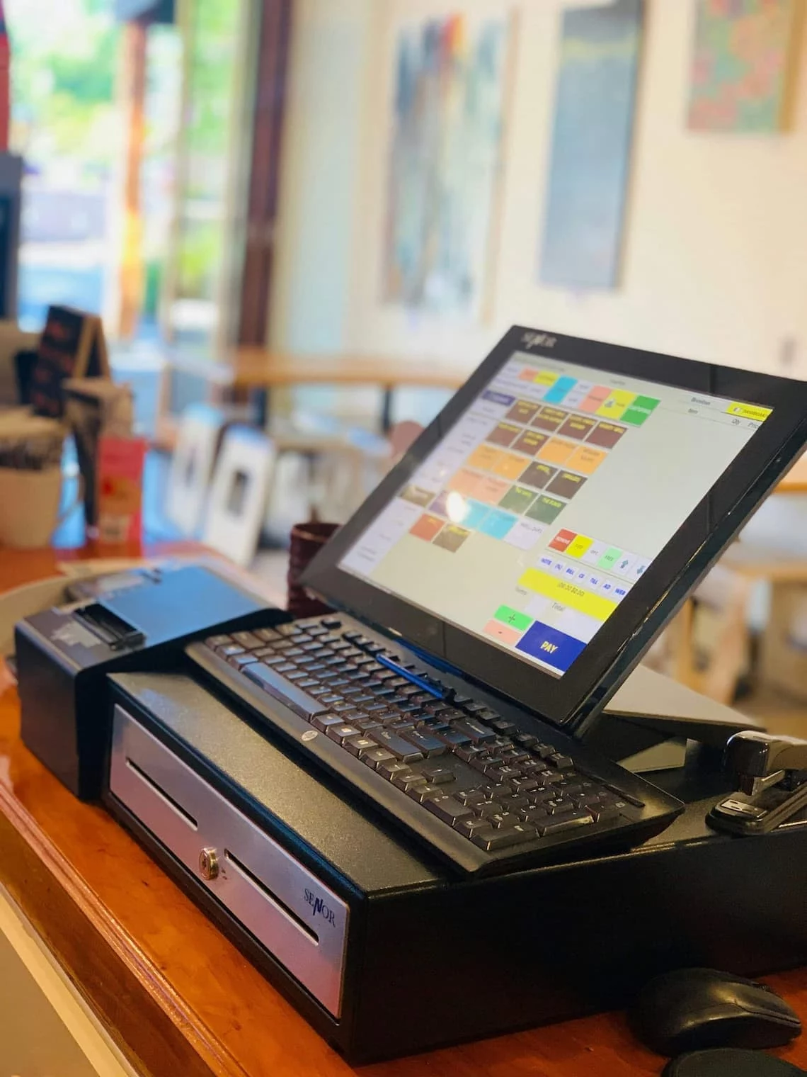 Touchscreen POS system with keyboard and cash drawer — the kind of hardware the pos lease buyout calculator runs the math for