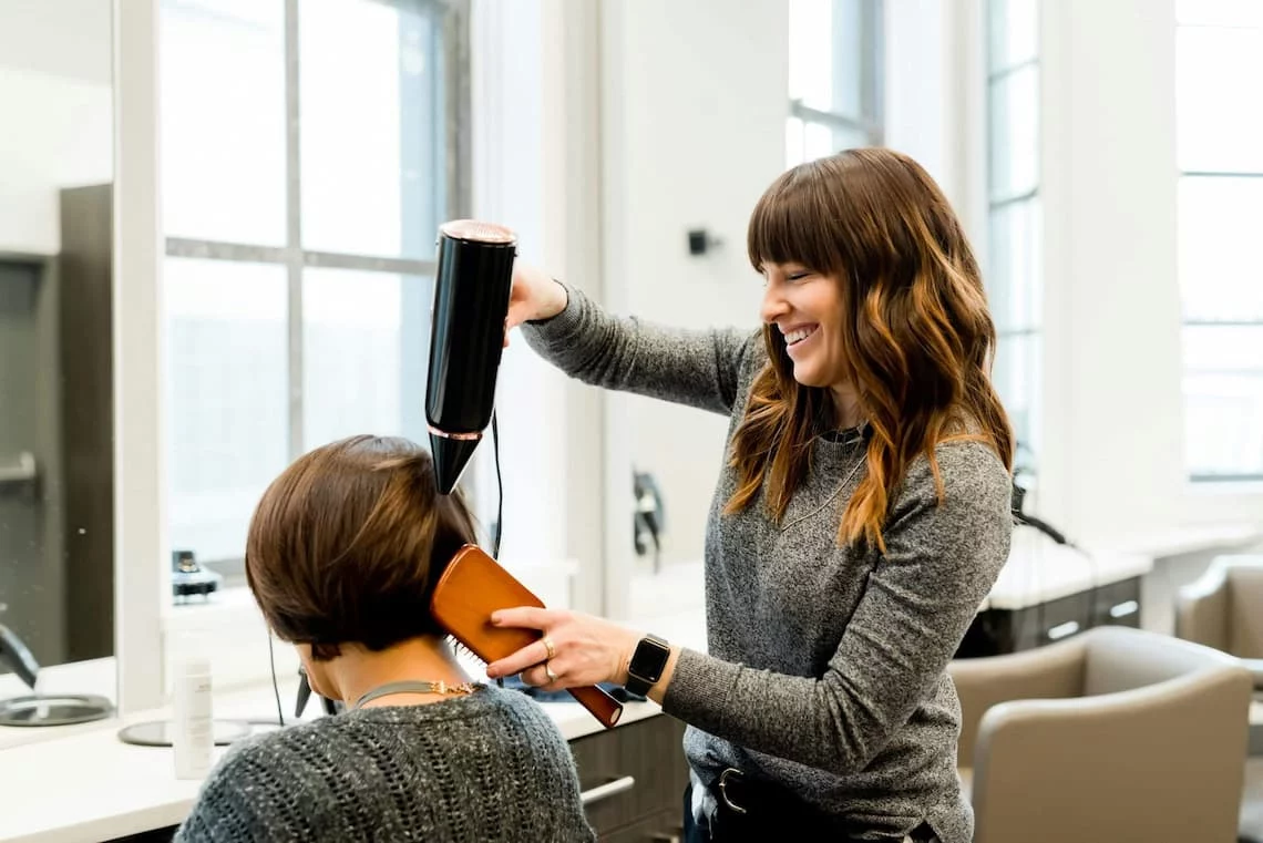 Salon payment processing setup at a busy hair salon where the stylist runs cards between appointments