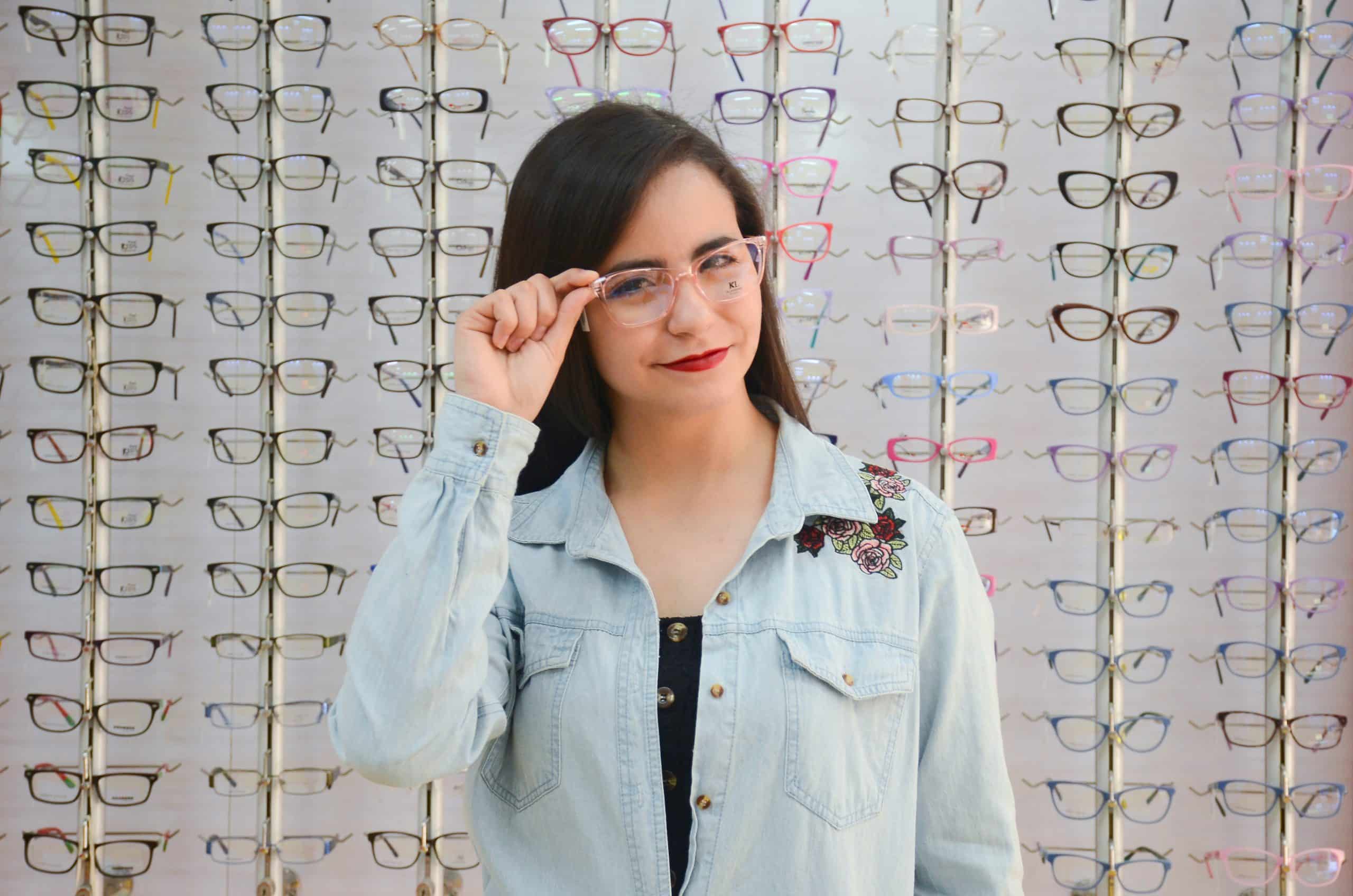 Optometry practice owner trying on glasses frames — Global Payments alternatives Marisol Vega