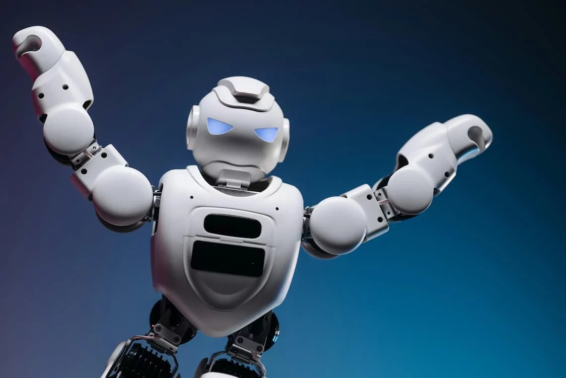 A friendly humanoid robot with arms raised, representing an AI agent arriving to handle agentic commerce checkout