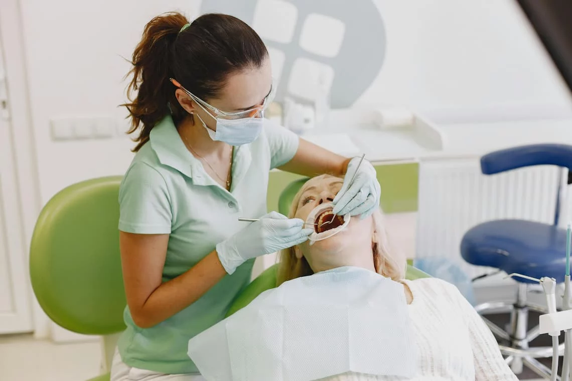 Dental practice owner reviewing statement to reduce Eaglesoft payments fees with merchant services consultant