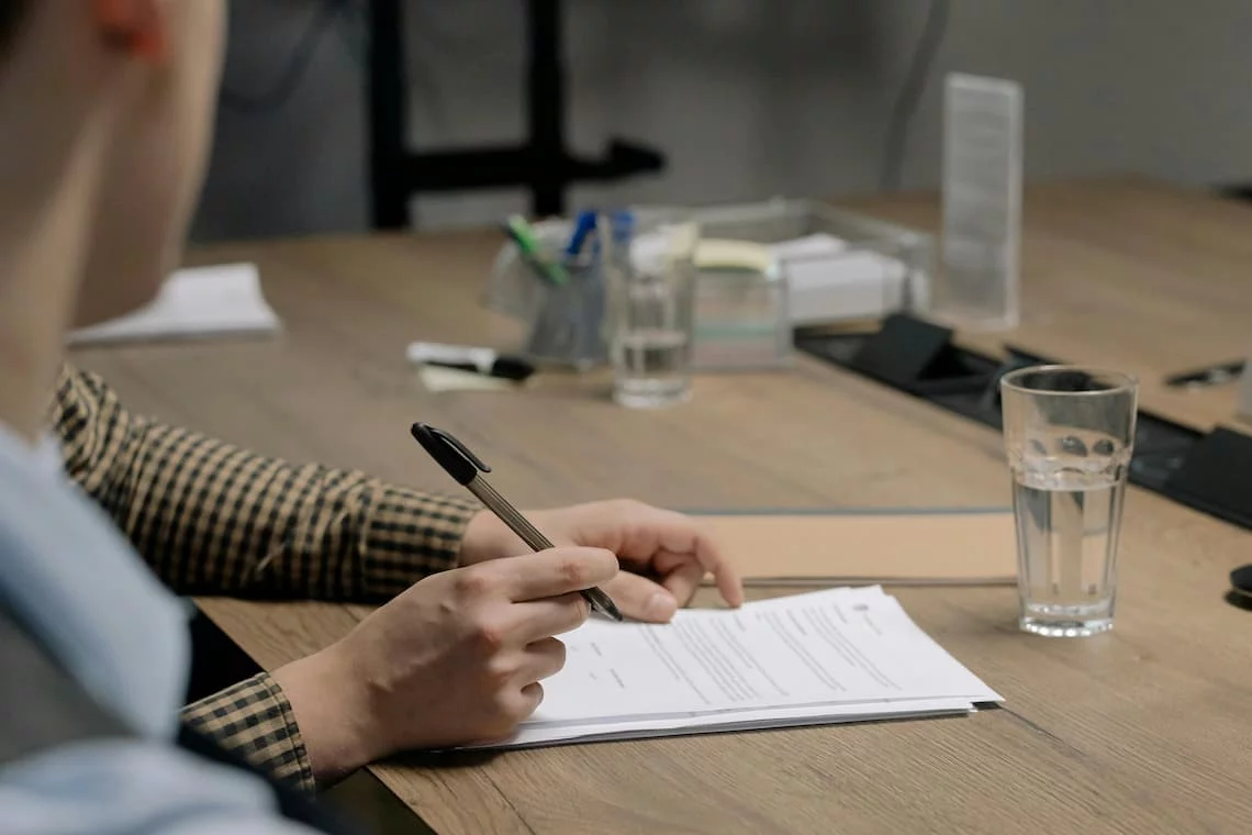 a business owner reviewing a multi-page merchant agreement contract before signing