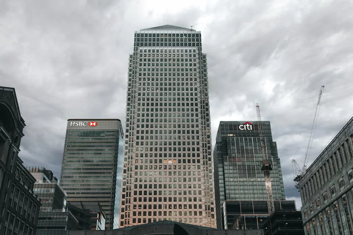 A financial district skyline representing pay by bank payments that move directly through the banking system