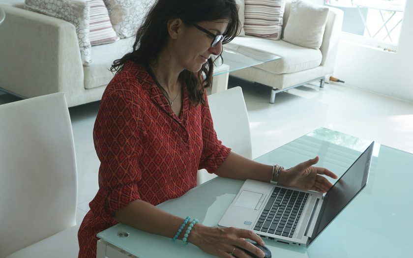 Susan Driscoll, business manager at a Catholic K-8 school in suburban Cleveland, reviewing a Heartland merchant processing statement on her kitchen table