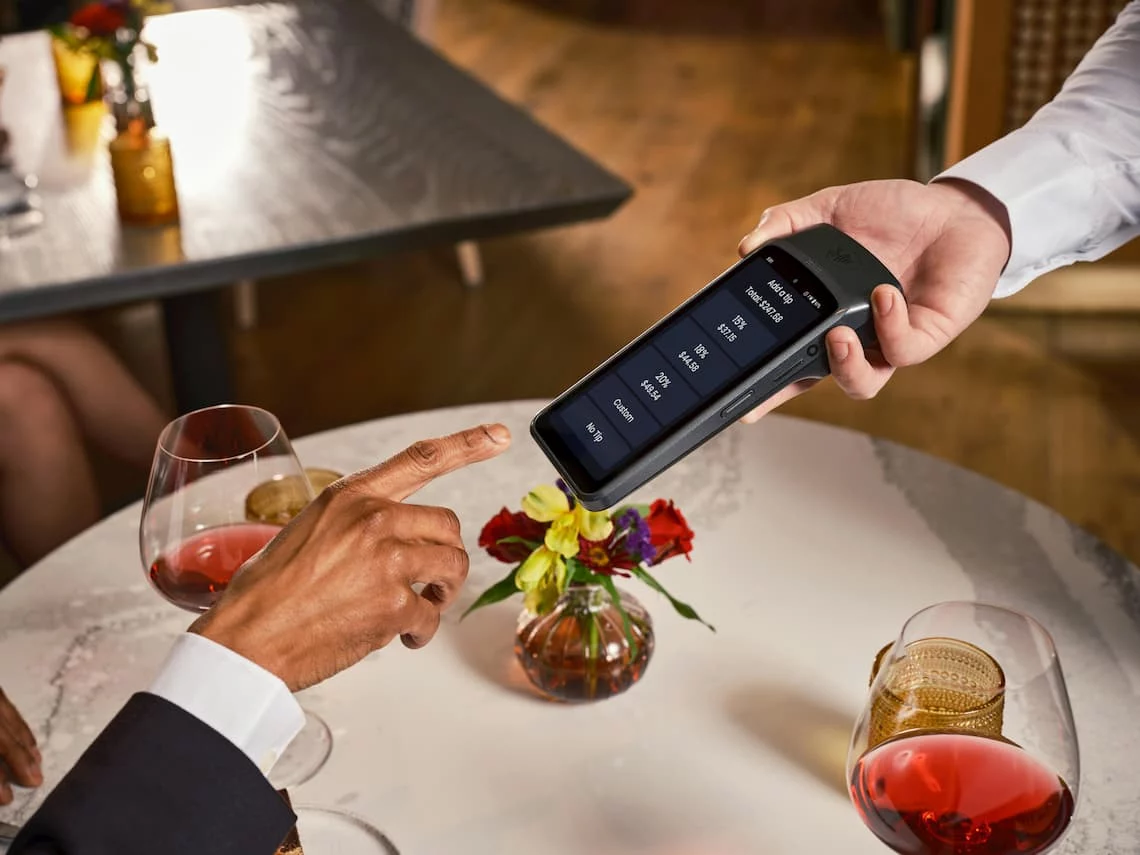 Restaurant card terminal showing a tip prompt — Illinois interchange on tax and gratuity