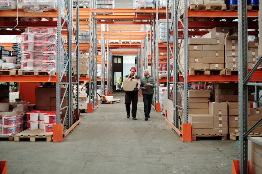 Owner of a janitorial and industrial supply distributor walking the warehouse floor, weighing a B2B surcharge against losing accounts