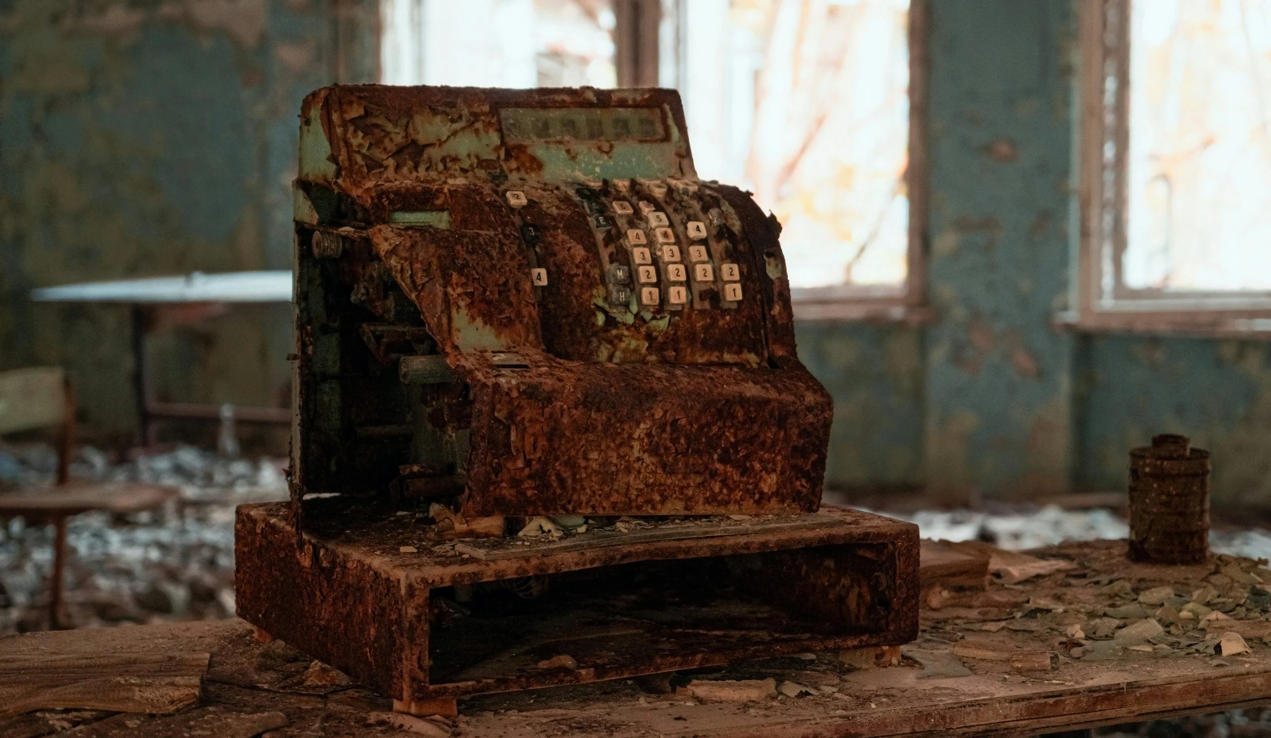 A rusted, abandoned cash register — what a credit card terminal leasing contract can outlive